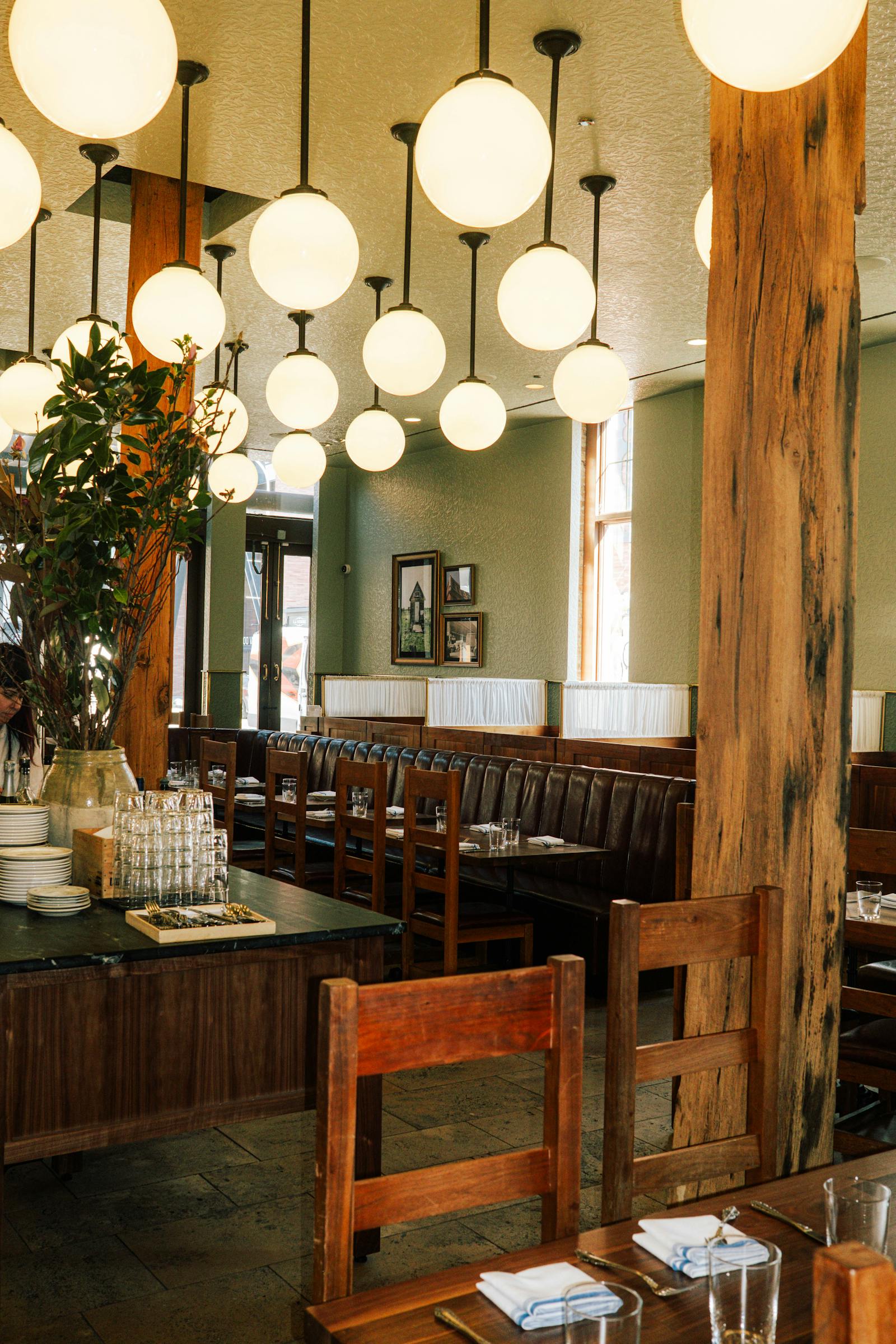 The Publican dining room with globe lights and long wooden tables